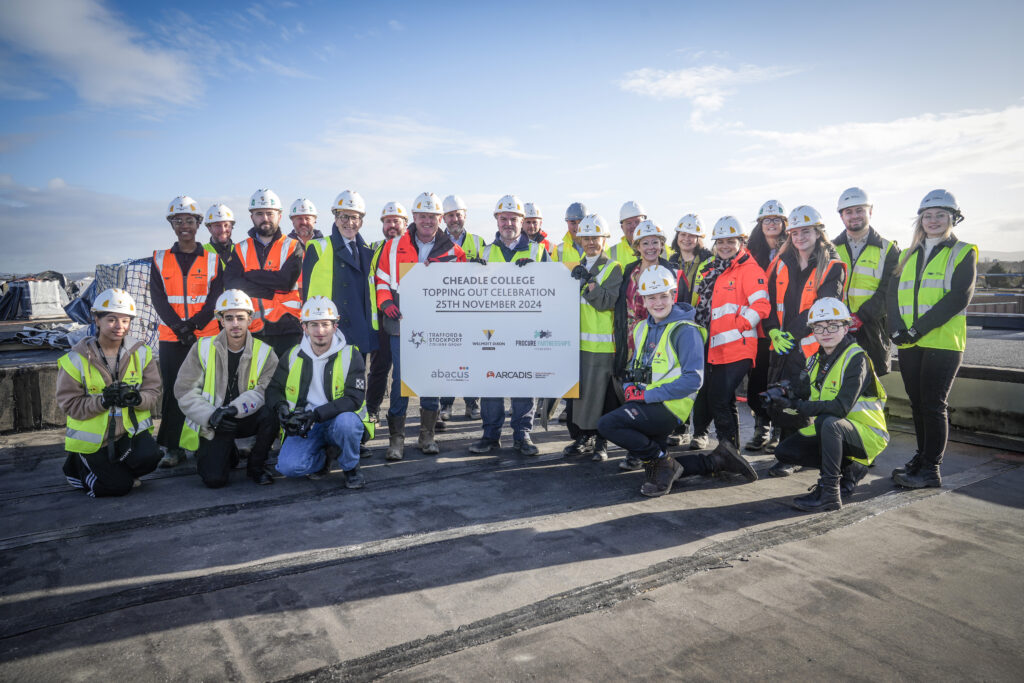 Picture shows: Students and staff from Cheadle College with the Willmott Dixon team celebrating the topping-out milestone at the new campus site.