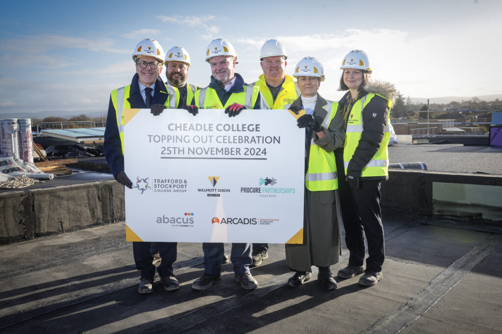 Picture shows: Students and staff from Cheadle College with the Willmott Dixon team celebrating the topping-out milestone at the new campus site.