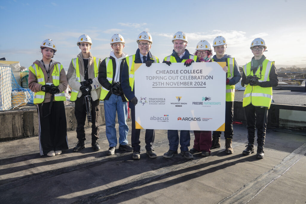 Picture shows: Students and staff from Cheadle College with the Willmott Dixon team celebrating the topping-out milestone at the new campus site.