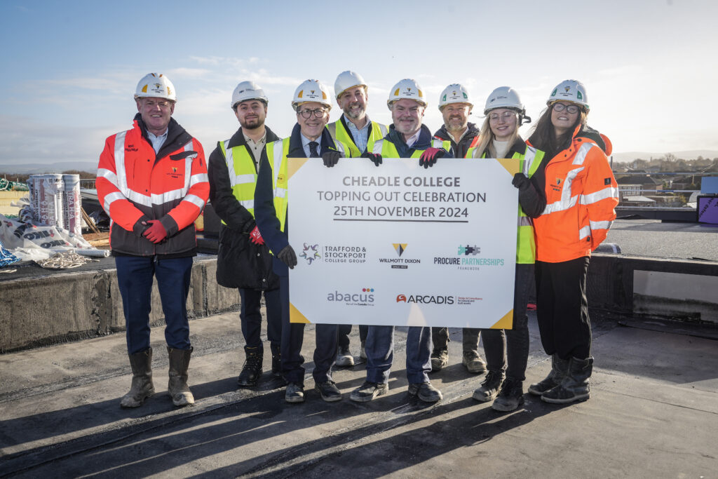 Picture shows: Students and staff from Cheadle College with the Willmott Dixon team celebrating the topping-out milestone at the new campus site.