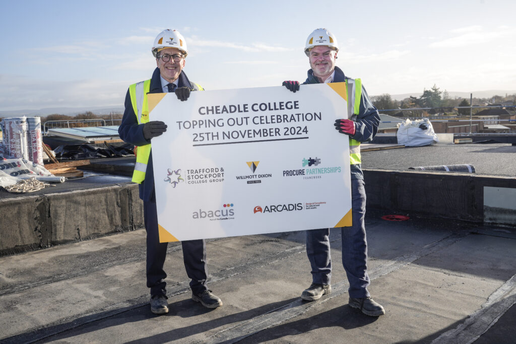 Picture shows the Principal from Cheadle College with the Willmott Dixon team lead celebrating the topping-out milestone at the new campus site.