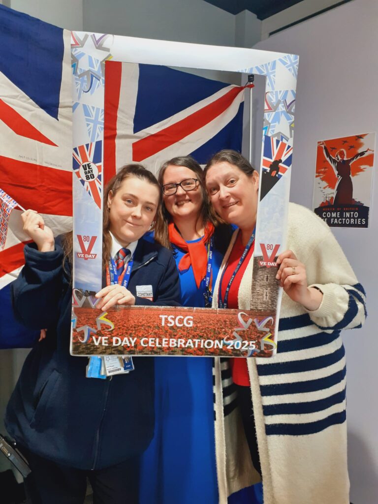 Staff with VE day celebration frame