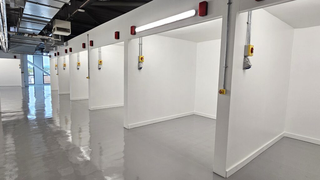 White row of training bays equipped with electrical sockets